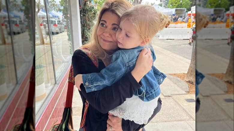 Lisa Whelchel holding her granddaughter