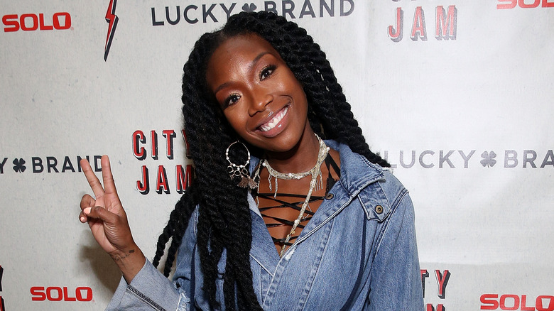 Brandy smiling and flashing peace sign