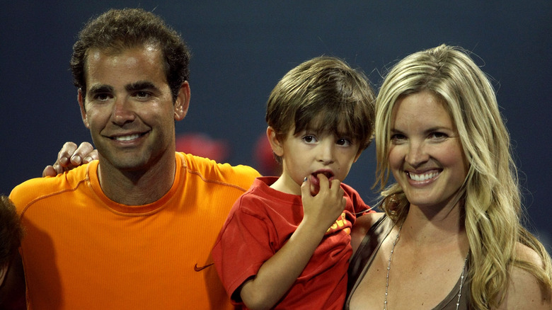 Pete Sampras posing with his son, Ryan, and wife, Bridgette Wilson-Sampras