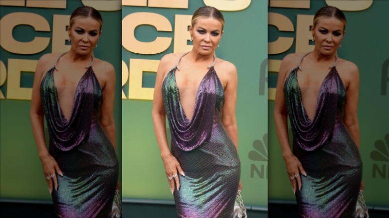 Carmen Electra posing in a shimmering purple gown 