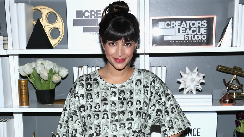 Hannah Simone smiling at event