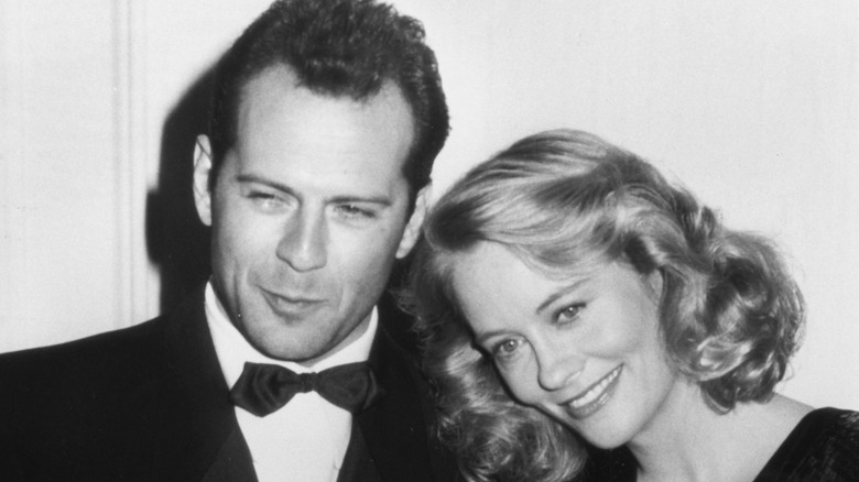 Cybill Shepherd leaning head on Bruce Willis' shoulder