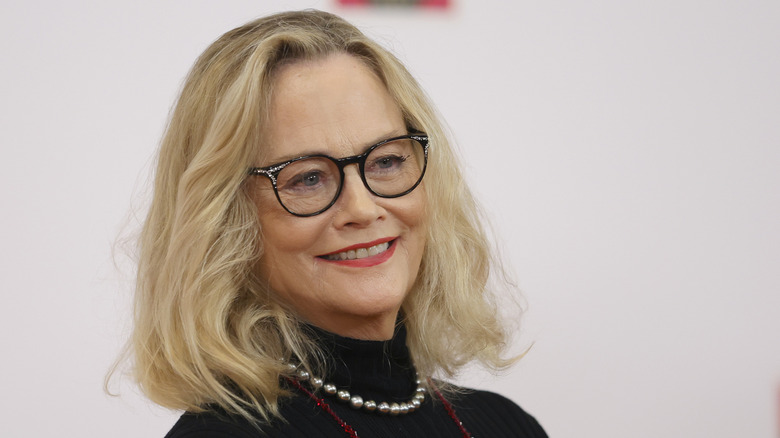 Cybill Shepherd smiling wearing glasses