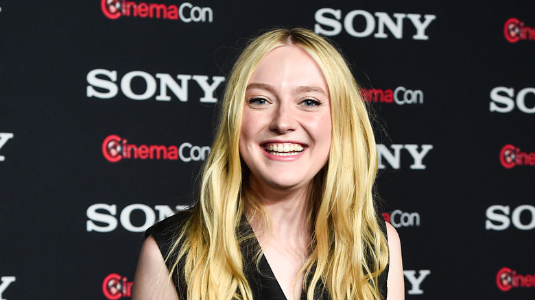 Dakota Fanning smiling at event