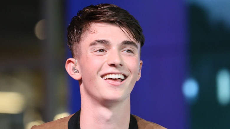 A teenage Greyson Chance, wearing an in-ear monitor, smiling