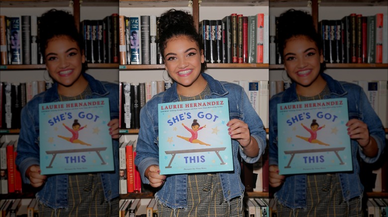 Laurie Hernandez poses with a book