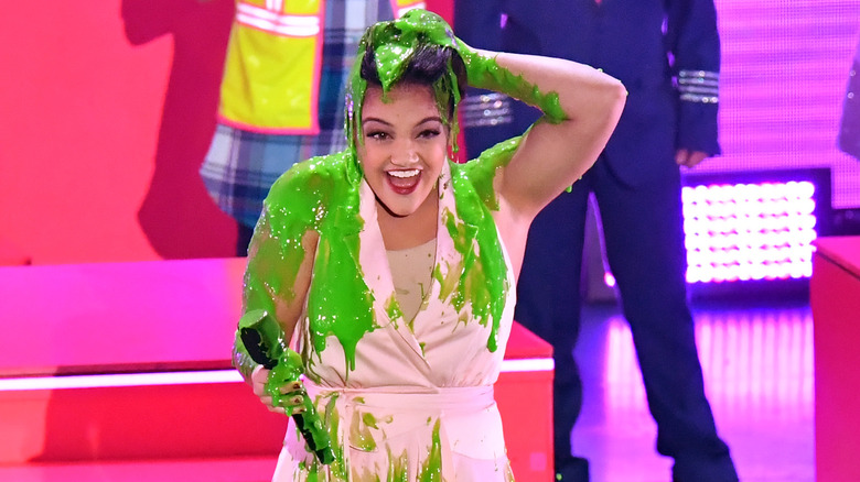 Laurie Hernandez smiles covered in green slime 