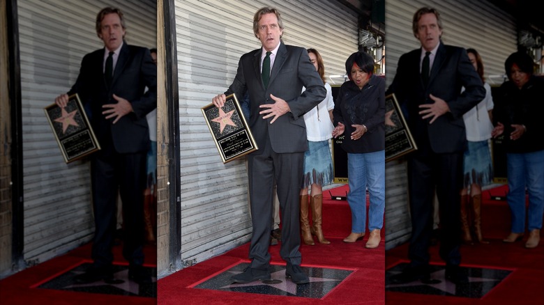 Hugh Laurie posing at the unveiling of his star on the Hollywood Walk of Fame in 2016.