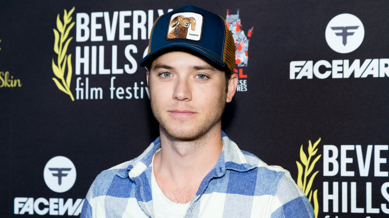 Jeremy Sumpter posing in a baseball cap