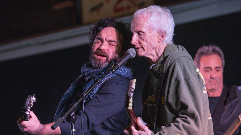 Johnny Galecki singing and playing guitar on stage with Robby Krieger of The Doors in 2020