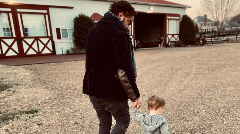 Johnny Galecki walking with his son at his farm