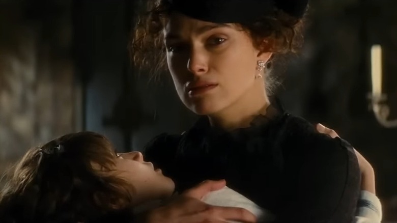 Keira Knightley holding a child in Anna Karenina