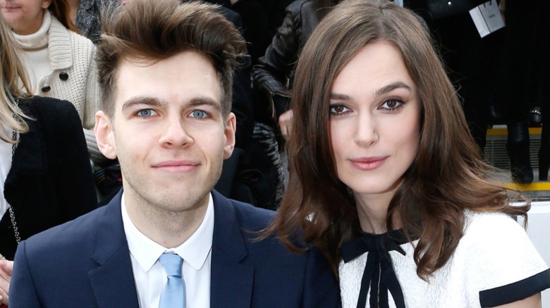 Keira Knightley and James Righton sitting at a fashion week event together