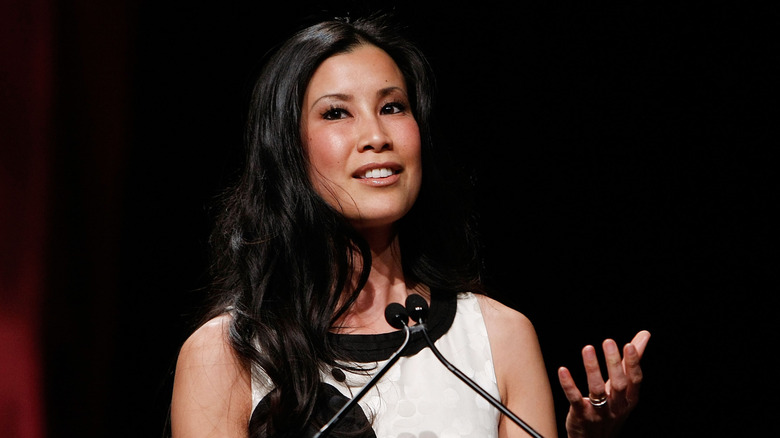 Lisa Ling speaking into a microphone