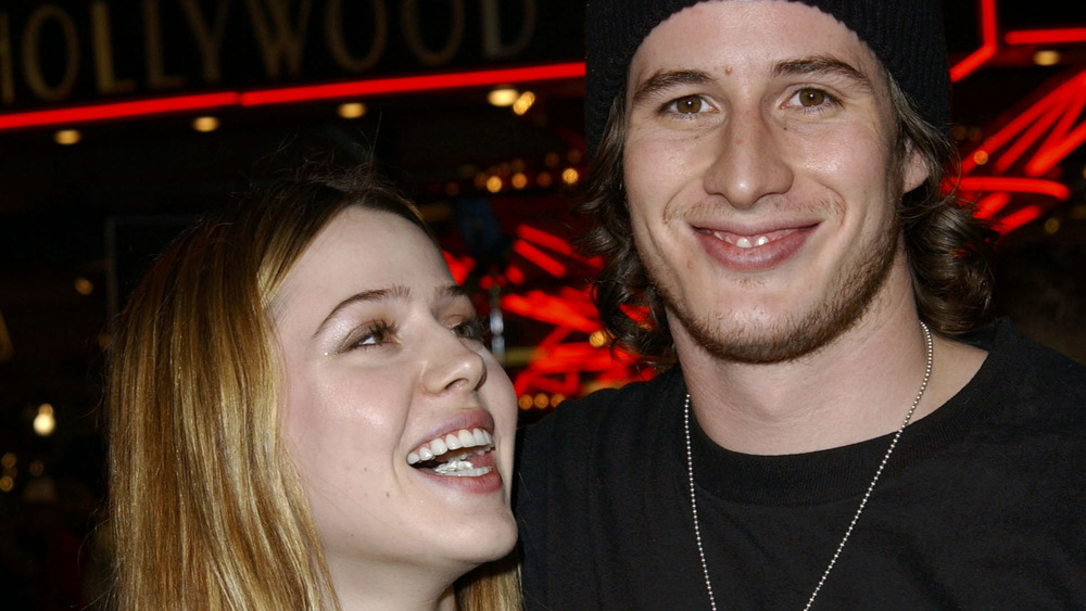 Majandra Delfino smiling at Brendan Fehr in beanie and black shirt