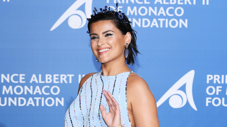 Nelly Furtado waving and smiling 