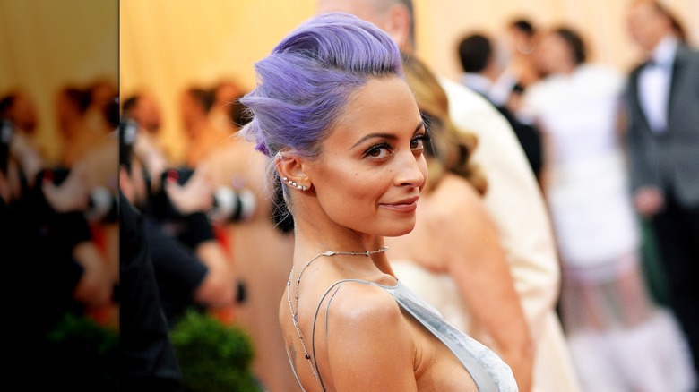 Nicole Richie posing with purple hair