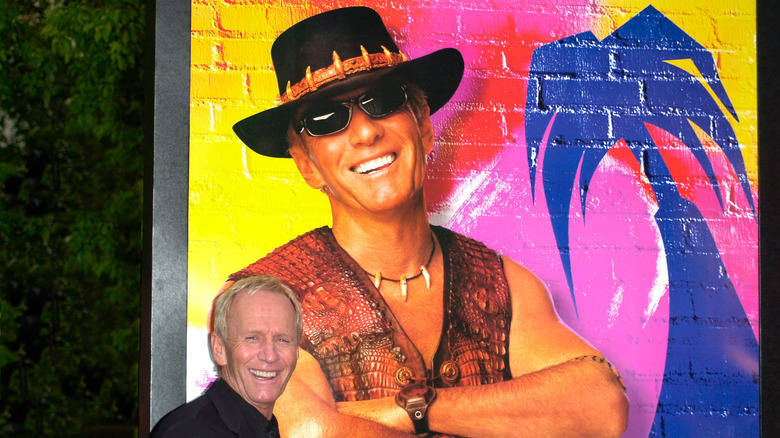 Paul Hogan with Crocodile Dundee poster