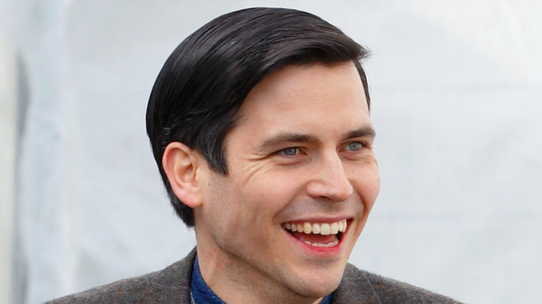 Rob James-Collier smiling on set