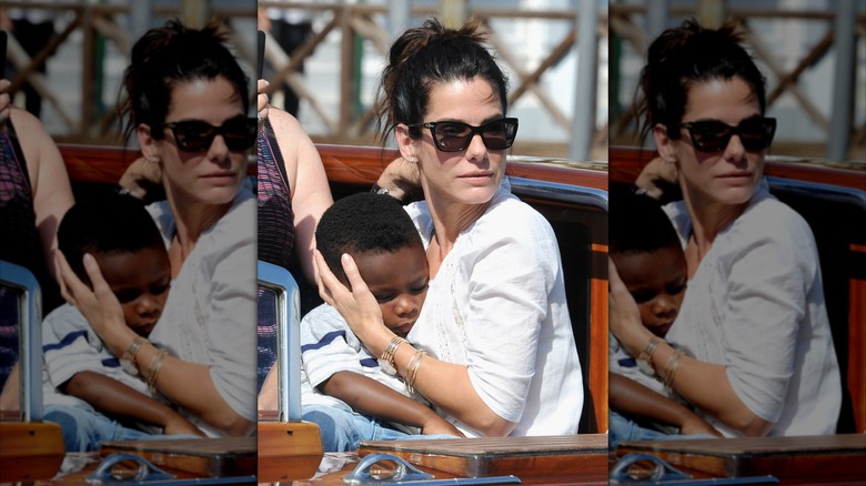 Sandra Bullock cradling her son at the Venice Film Festival in 2013