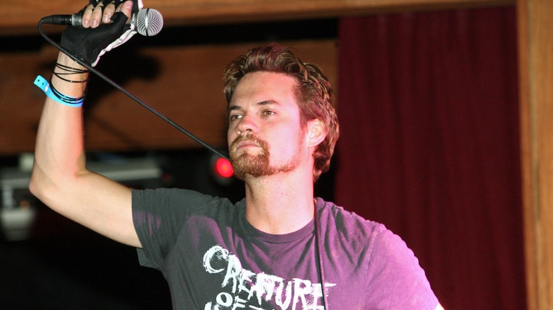 Shane West holding a microphone