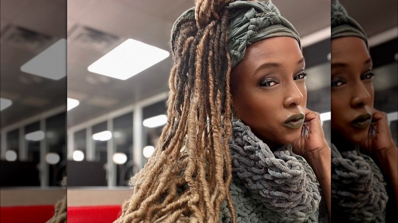 Trina McGee posing in a grey scarf