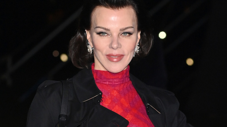 Debi Mazar half-smiling at the Burberry winter 2024 show