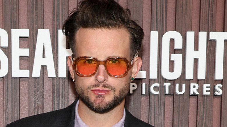 Nico Tortorella posing at the Kinds of Kindness premiere