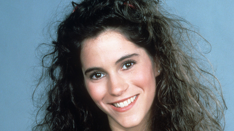 Young Jami Gertz with curly hair