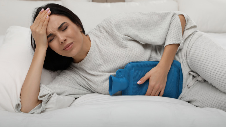 A woman relieving period pain