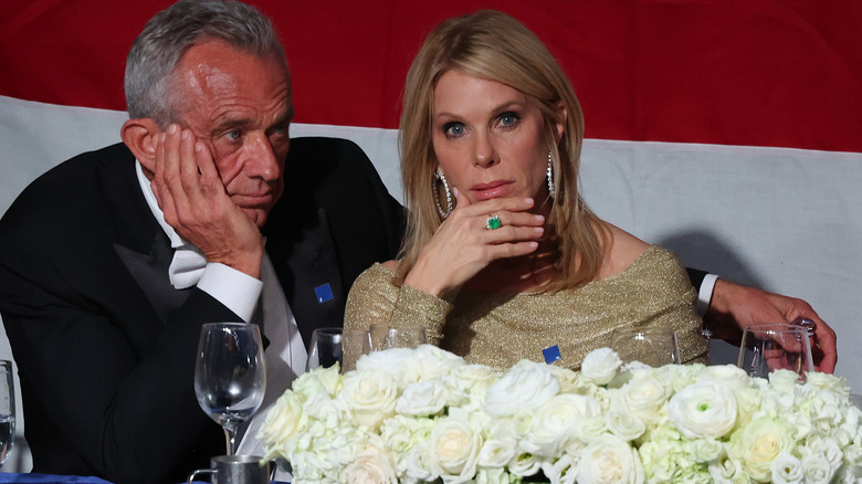 RFK Jr and Cheryl Hines sitting at table resting heads on hands