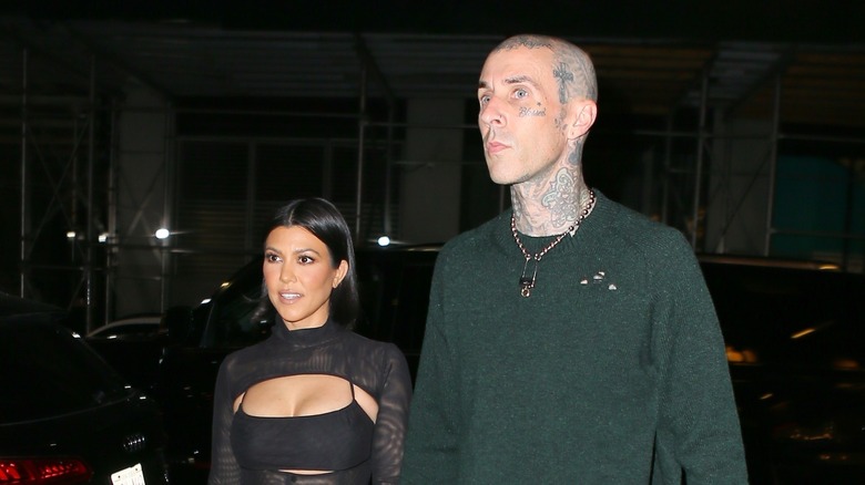 Travis Barker and Kourtney Kardashian hold hands