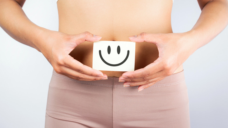 Smiley face over a woman's stomach