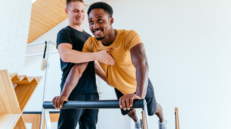 Man using pilates reformer machine 