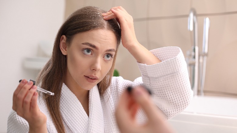 Woman treating dandruff at home