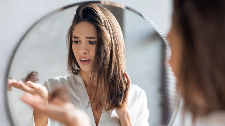 Woman holding clump of hair