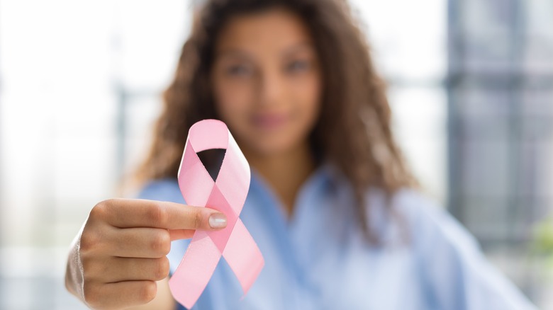 Woman holding breast cancer ribbon