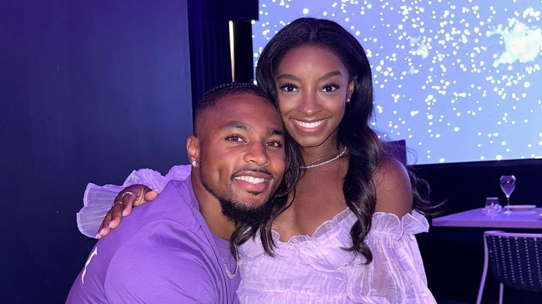 Simone Biles and Jonathan Owens smiling and hugging