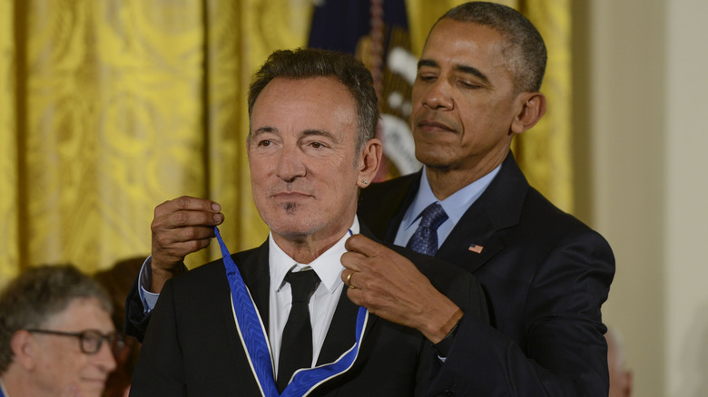 Barack Obama giving Bruce Springsteen medal