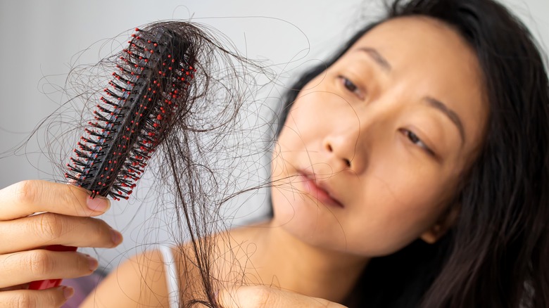 Woman looking at hair loss