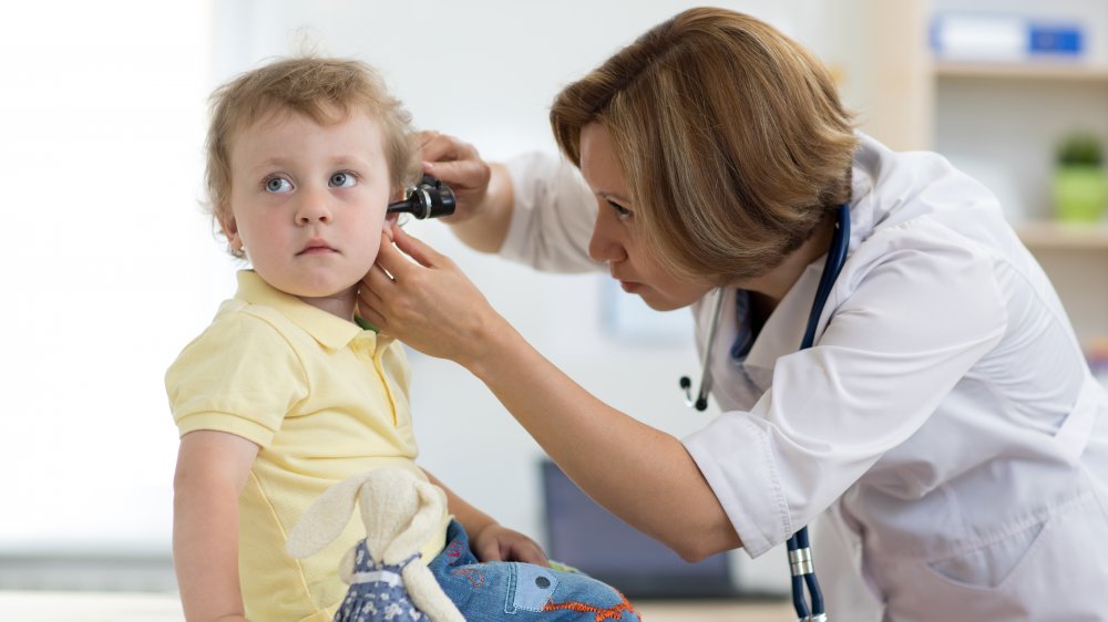 child at doctor's office getting ears examined