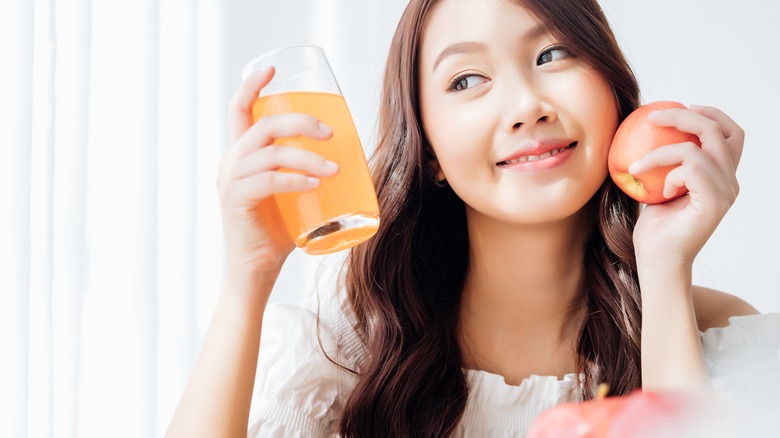 a woman with an apple and apple juice