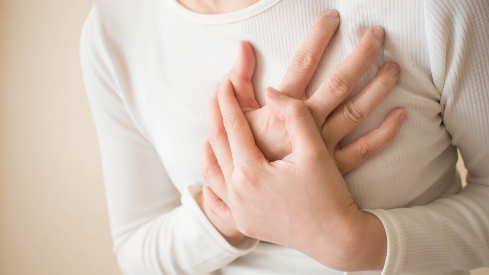 woman holding chest