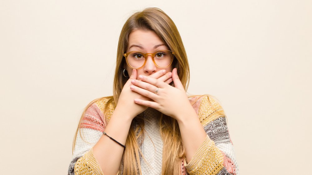 woman covering mouth