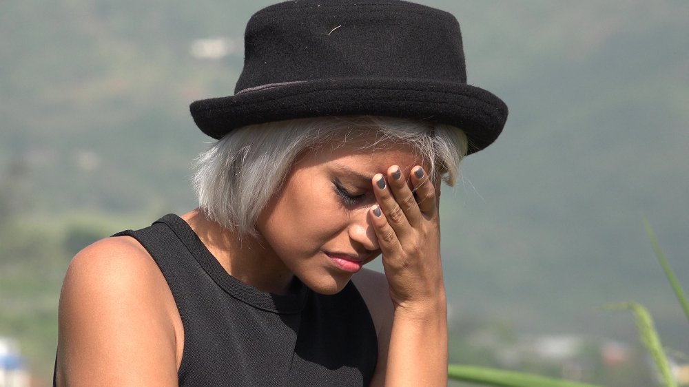 stressed woman with hand on face