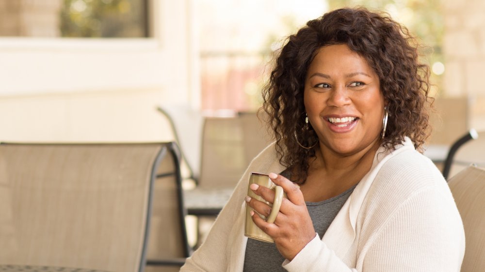 A happy woman drinking coffee