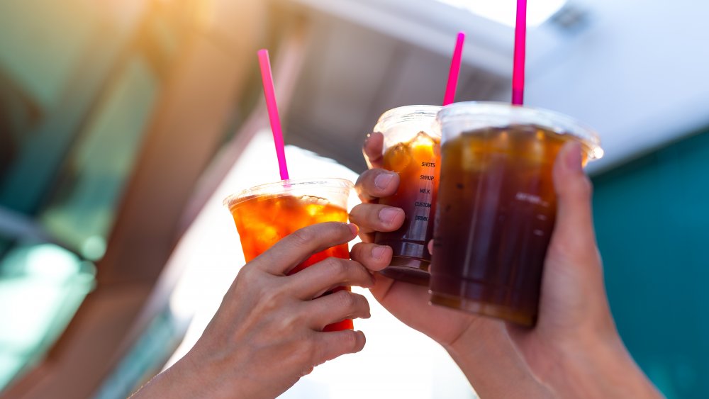 Hands holding cups of iced coffee