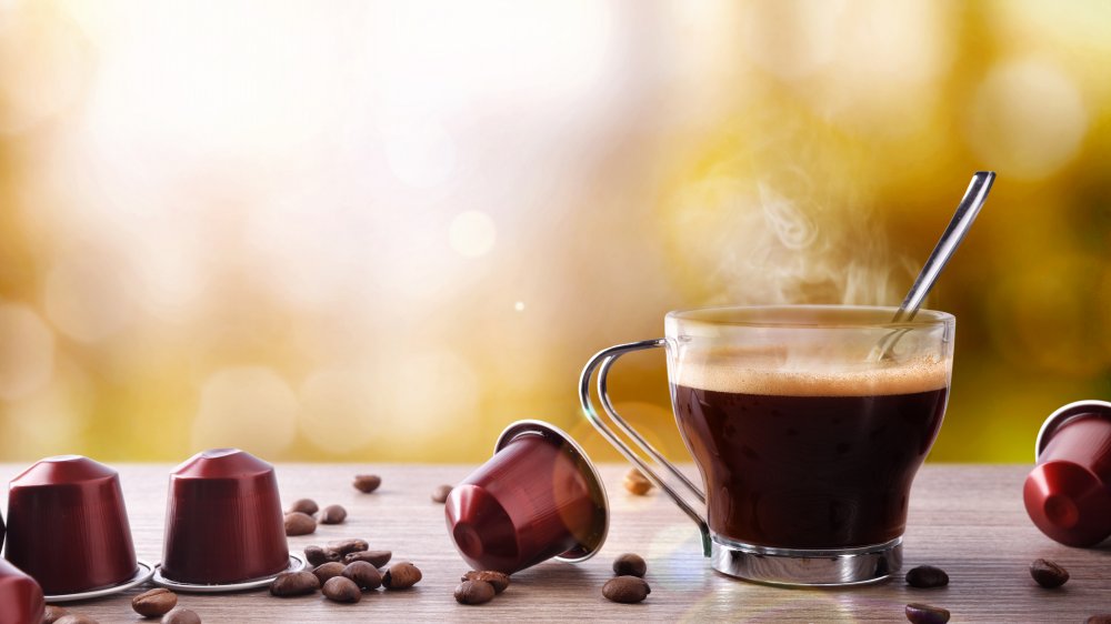 Coffee cup with beans and pods