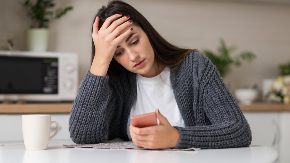 frustrated woman with tea nearby