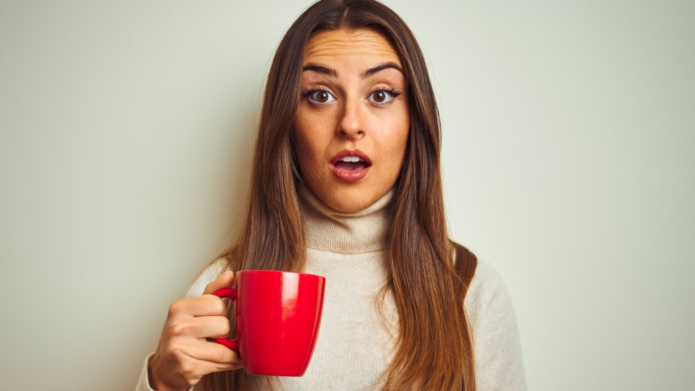 shocked woman drinking tea